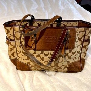 Coach signature purse with brown suede accents.